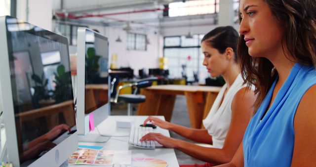 Two Women Focused on Work at Modern Office Desks - Download Free Stock Photos Pikwizard.com