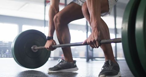 Man performing deadlift exercise in gym