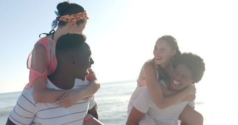 Joyful Friends Having Fun at Sunny Beach, Piggyback Rides, Diverse Group