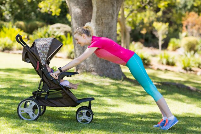 Woman performing push-ups using baby stroller in park. Ideal for promoting fitness, active parenting, and outdoor exercise. Suitable for health and wellness blogs, parenting magazines, and fitness programs.