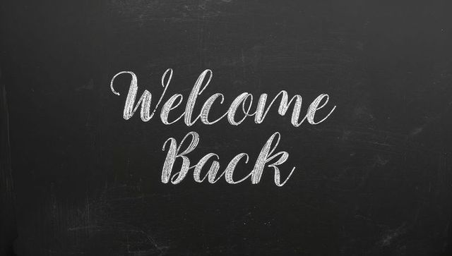 Welcome back chalkboard message in classroom