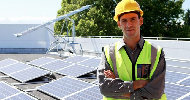 Engineer stands confidently on rooftop with solar panels, highlighting the shift towards renewable energy and sustainability in construction. Use for editorial articles, ads focusing on green energy solutions, marketing materials promoting solar technology, or educational content about renewable energy.