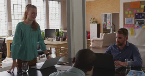 Diverse Team Brainstorming in Modern Creative Office