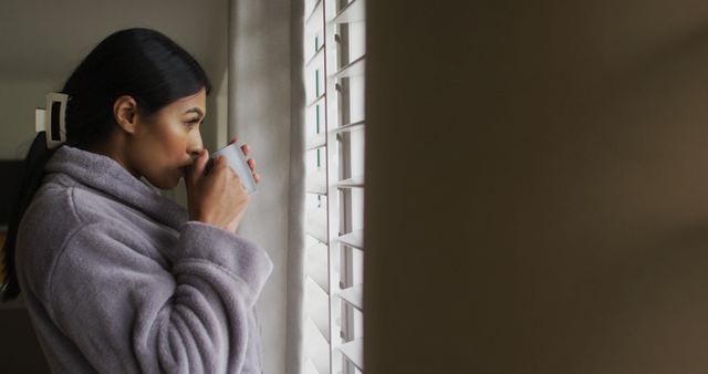 Woman Drinking Coffee and Looking Out Window at Home - Download Free Stock Images Pikwizard.com