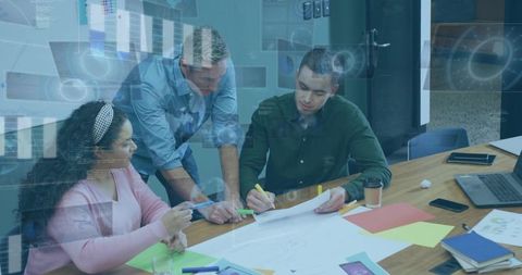 Cross-Functional Team Reviewing Plans and Brainstorming Design Ideas Around Office Table