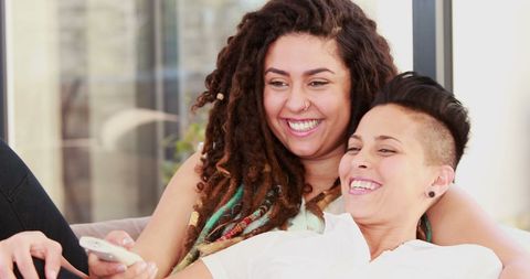 Happy Couple Sharing Joyful Moment with Smartphone
