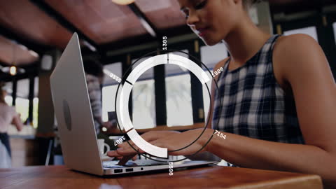 Young Woman Engaged with Digital Data Analytics on Laptop