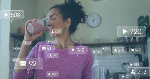 Mature woman drinking pink smoothie in home kitchen with social media engagement overlays