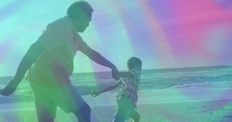 Joyful Grandfather and Grandson Holding Hands at the Beach