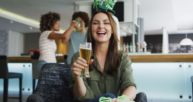 Young adults celebrating St. Patrick's Day at home, with cheerful expressions, drinking beer. Can be used to depict holiday celebrations, friendship, and enjoyment of festive events.
