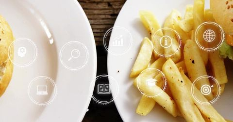 Crispy golden fries and burger with floating digital icons illustrating food delivery tech