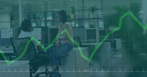 Colleagues collaborating in modern open-plan office with green financial graph overlay