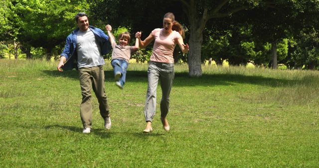 Young Parents Swinging Happy Child at Park - Download Free Stock Images Pikwizard.com