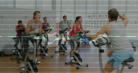 Adults Pedaling Energetic Indoor Spin Class with Instructor and Fitness Data Overlay
