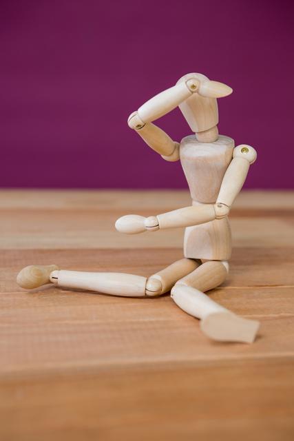 Conceptual image of figurine performing stretching exercise