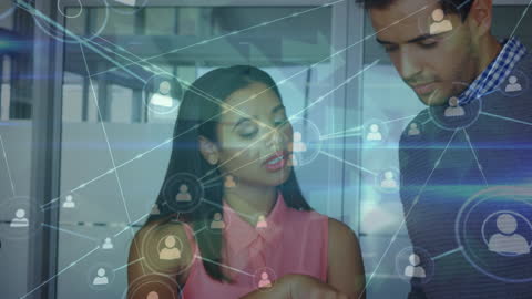 Coworkers Discussing Network Connections Technology in Modern Office