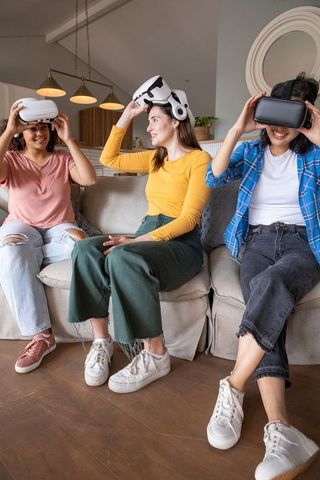 Diverse Female Friends Using VR Headsets in Modern Living Room