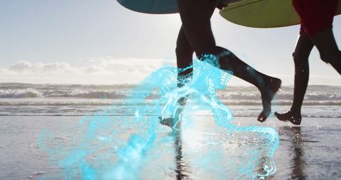 Surfers running into ocean with vivid turquoise effect