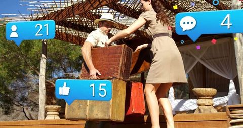 Couple handling suitcases in safari outfit with social media icons