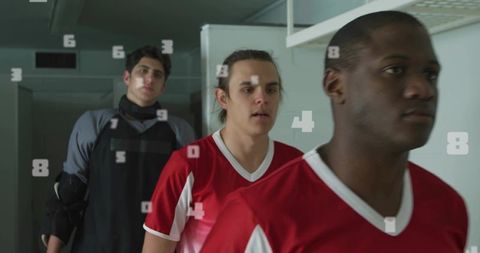 Team players walking down hallway wearing red jerseys with number overlay
