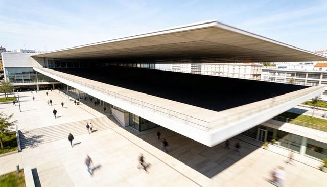 Dominating cantilever concrete roof casting vast shaded courtyard over modern urban plaza