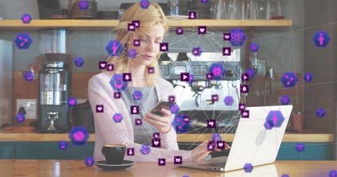 Tech-savvy woman innovating in cafe with laptop and smartphone