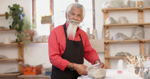 Senior Man in Art Studio Molding Clay with Smile - Download Free Stock Images Pikwizard.com