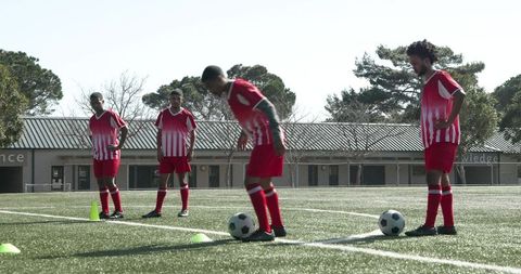 Young soccer players practicing drills on field