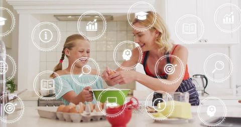 Mother guiding daughter cracking eggs and mixing batter in bright white kitchen smiling