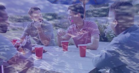 Friends socializing outdoors, relaxed picnic vibe