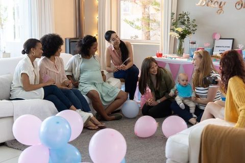Diverse women enjoying lively baby shower celebration