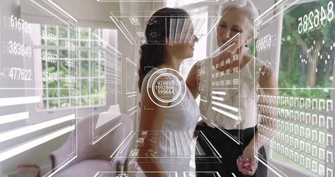 Senior Mother Adjusting Bride's Sleeveless Wedding Gown with HUD Overlay in Sunlit Room