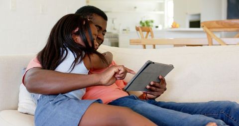 Father and Daughter Bonding with Tablet in Cozy Living Room