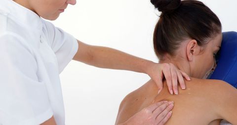 Massage Therapist Treating Patient for Back Pain
