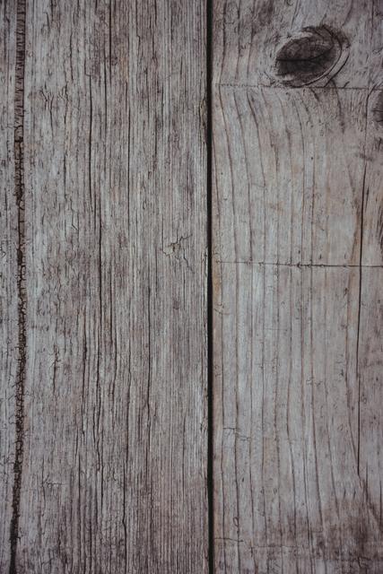 Rustic weathered wooden plank wall background showing natural texture and aged wood. Ideal for use in design projects, websites, or presentations needing a vintage or countryside aesthetic. Perfect for backgrounds, wallpapers, or as a texture overlay in graphic design.
