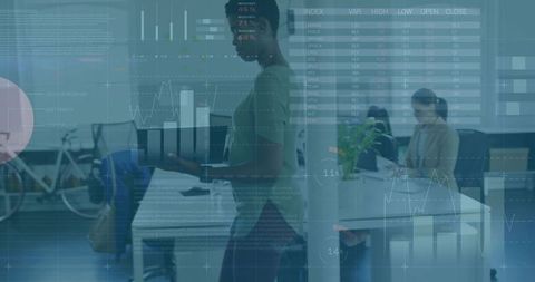 Woman Presenting Laptop in Modern Open Office Showing Analytics Dashboards and Charts