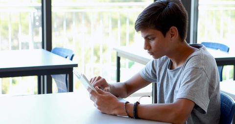 Teenage Boy Engaging with Tablet at Study Table - Download Free Stock Images Pikwizard.com