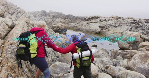 Couple Hiking Rocky Coastal Trail in Scenic Waistland