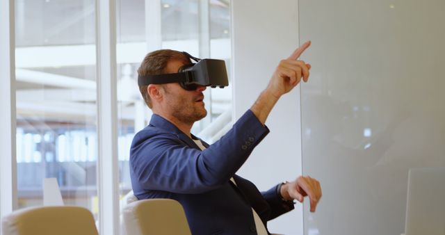 Businessman Engaging with Virtual Reality in Modern Office - Download Free Stock Images Pikwizard.com