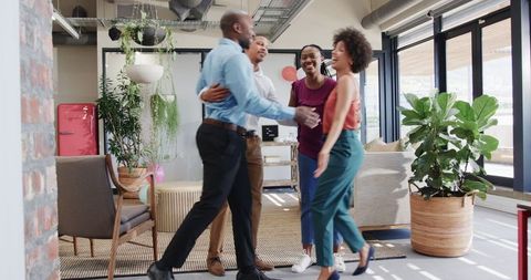 Joyful Business Team Celebrating Success in Modern Office Space