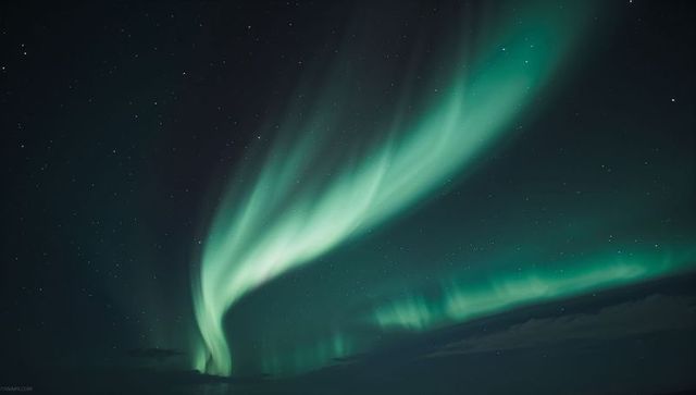 Mesmerizing Aurora Borealis Illuminates Starry Arctic Night
