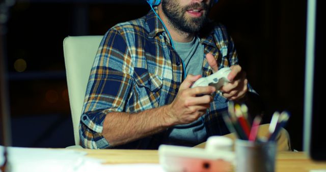 Man Playing Video Game with Headphones at Night - Download Free Stock Images Pikwizard.com