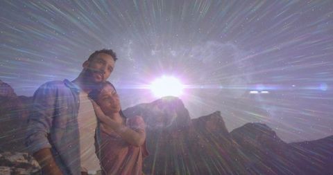 Couple Enjoying Sunset Over Mountain Landscape With Lens Flare