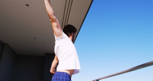 Man Stretching in Morning on Balcony - Download Free Stock Images Pikwizard.com