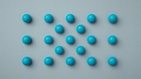 Geometric Pattern of Blue Spheres on Gray Surface