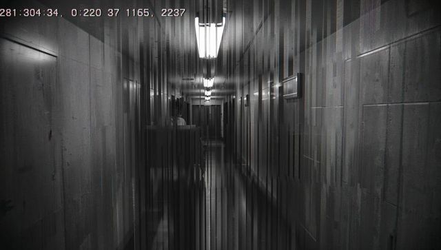 Glitched cctv corridor under fluorescent lights with timestamp and distorted reflections