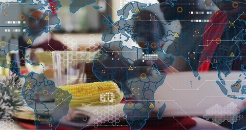 Corn on plate with global food supply data overlay, laptop and casual dining table scene