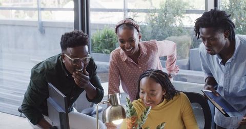 Diverse team laughing during creative brainstorming in office