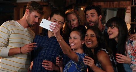 Diverse Group of Friends Enjoying Social Gathering, Taking Selfie