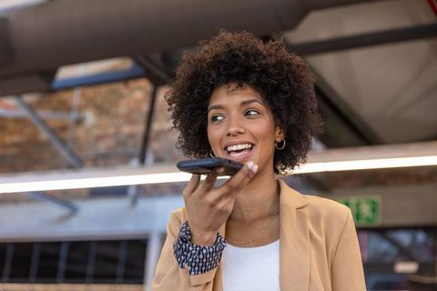 Confident professional using smartphone in industrial office
